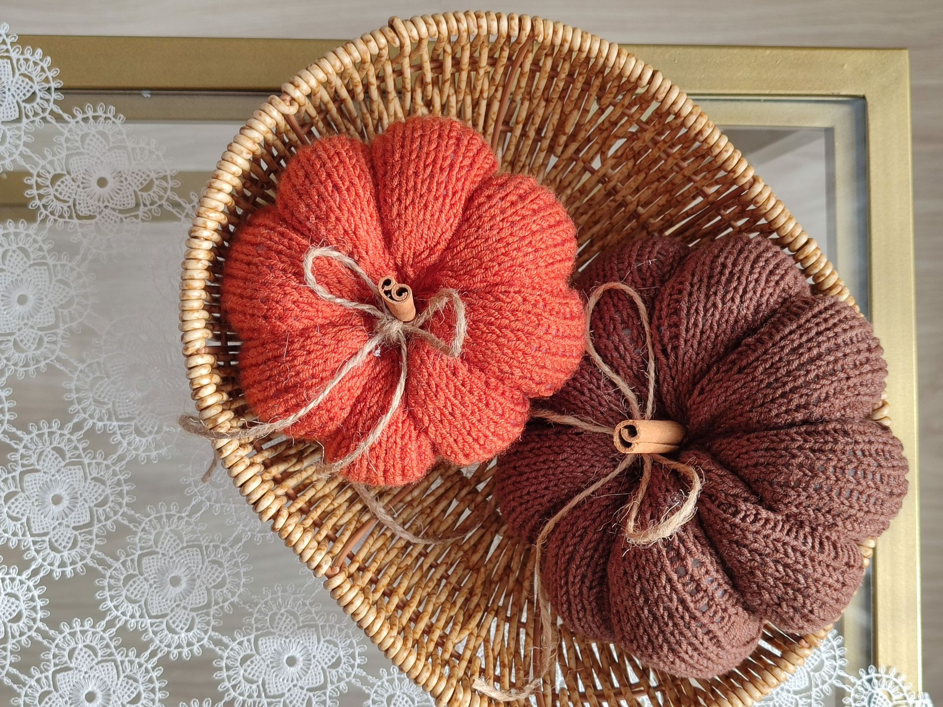 Elemanta Boutique Hotel | Two textured fabric pumpkins, one coral and one brown, in a woven basket on a table