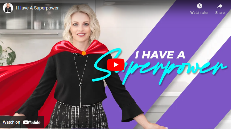 Woman in red cape, black outfit, with text “I HAVE A Superpower” and YouTube play icon