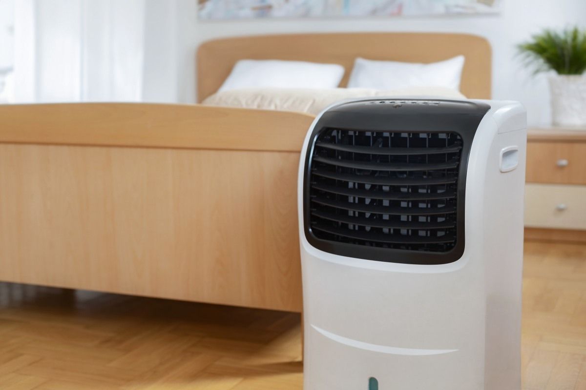 White and Black Portable Air Cooler in A Bedroom — MAE Refrigeration In Edmonton, QLD