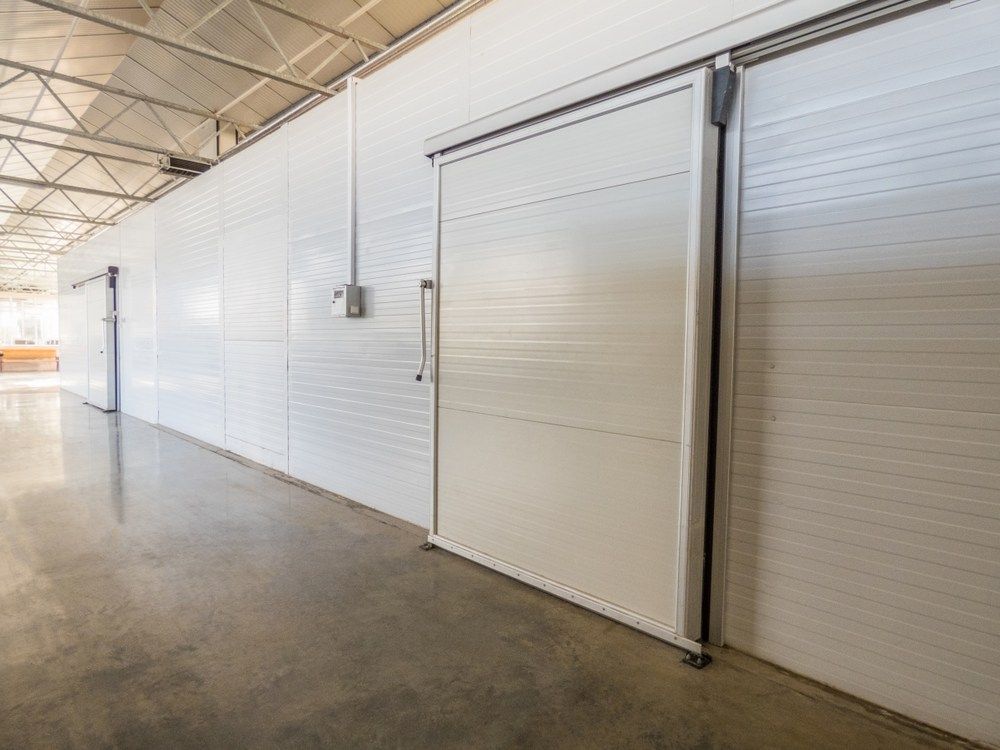 White Industrial Sliding Door in A Warehouse — MAE Refrigeration In Gordonvale, QLD