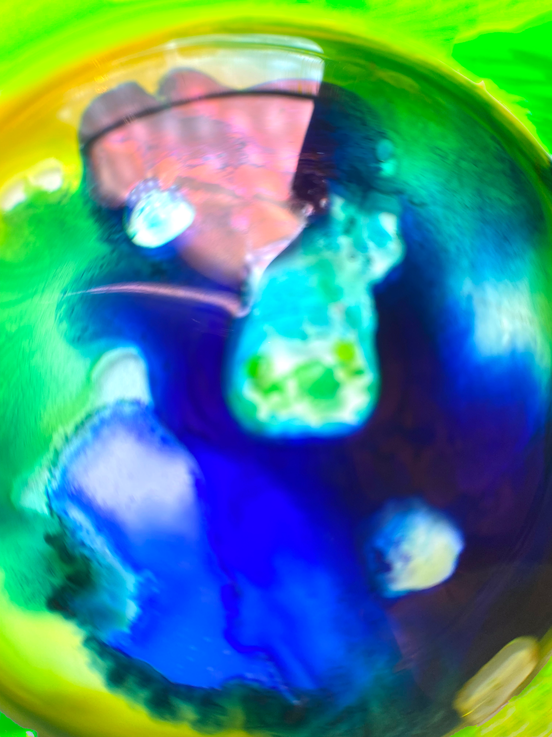 Abstract multicolored swirl with bright blue, green, yellow, and pink shapes in a circular form