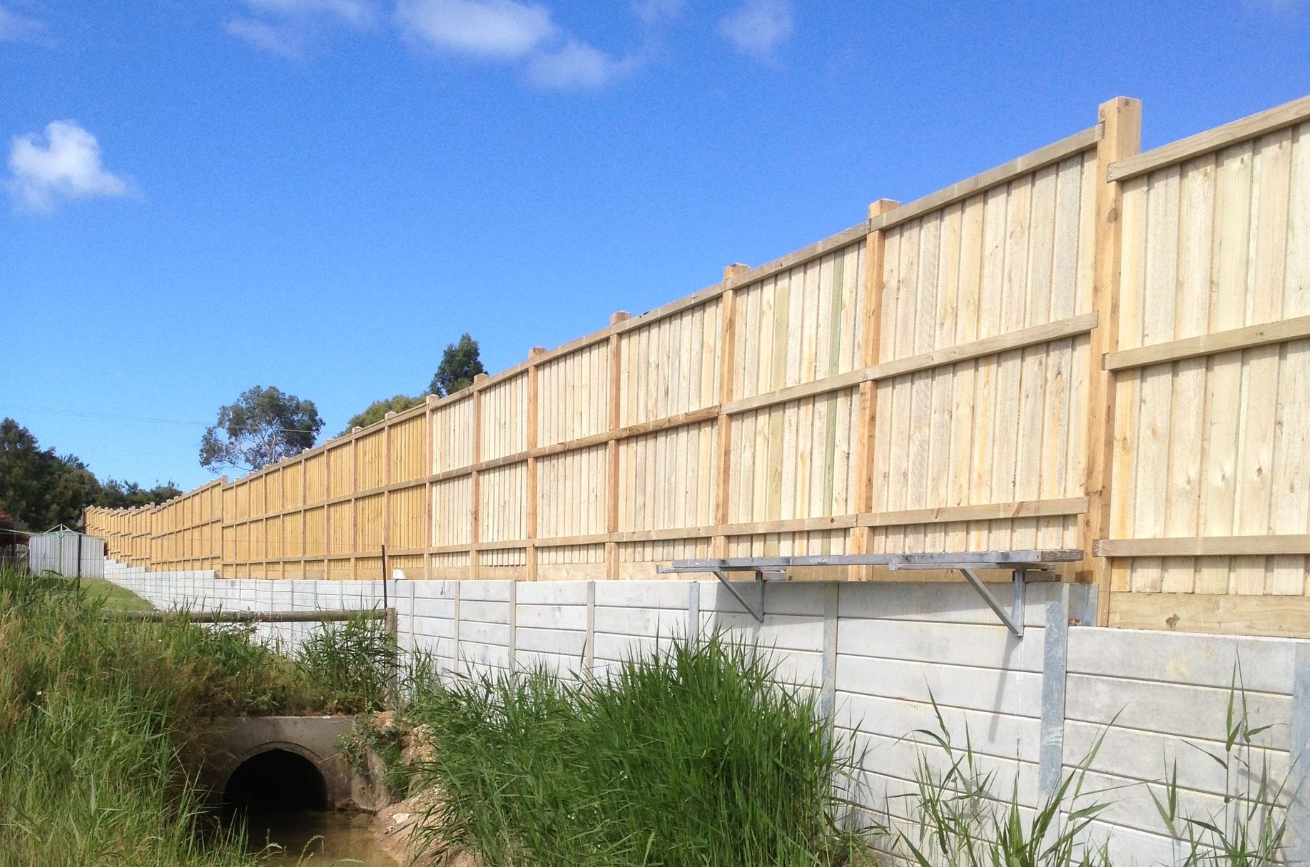 A Mailbox is Sitting Next to a Fence in the Middle of a Forest — Aztech Fencing In Harrington, NSW