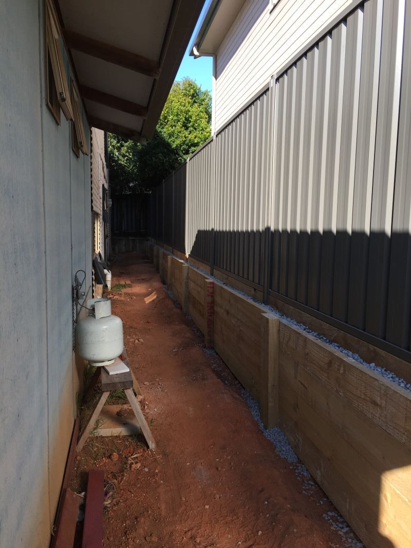 A Narrow Alleyway Between Two Houses With a Fence — Aztech Fencing In Bonny Hills, NSW