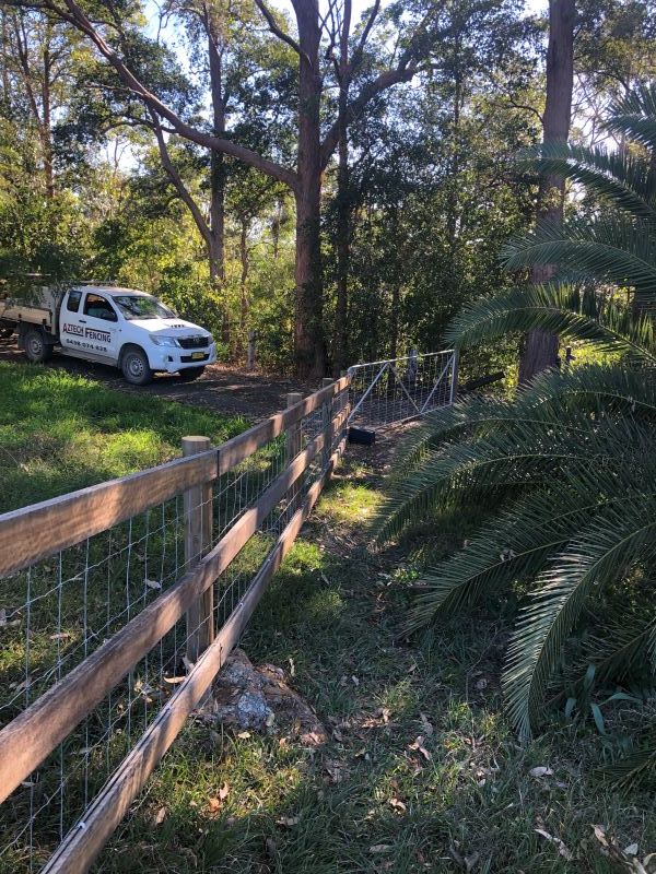 A White Truck is Parked Next to a Wooden Fence — Aztech Fencing In Upsalls Creek, NSW