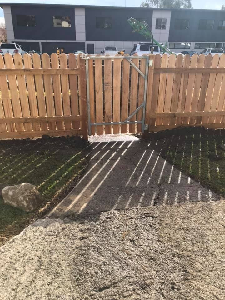 A Wooden Fence With a Gate in the Middle of It — Aztech Fencing In Harrington, NSW