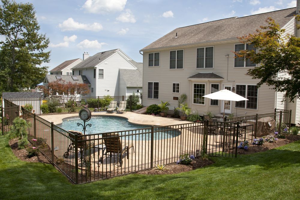 A Large House With a Large Swimming Pool in the Backyard — Aztech Fencing In Wauchope, NSW
