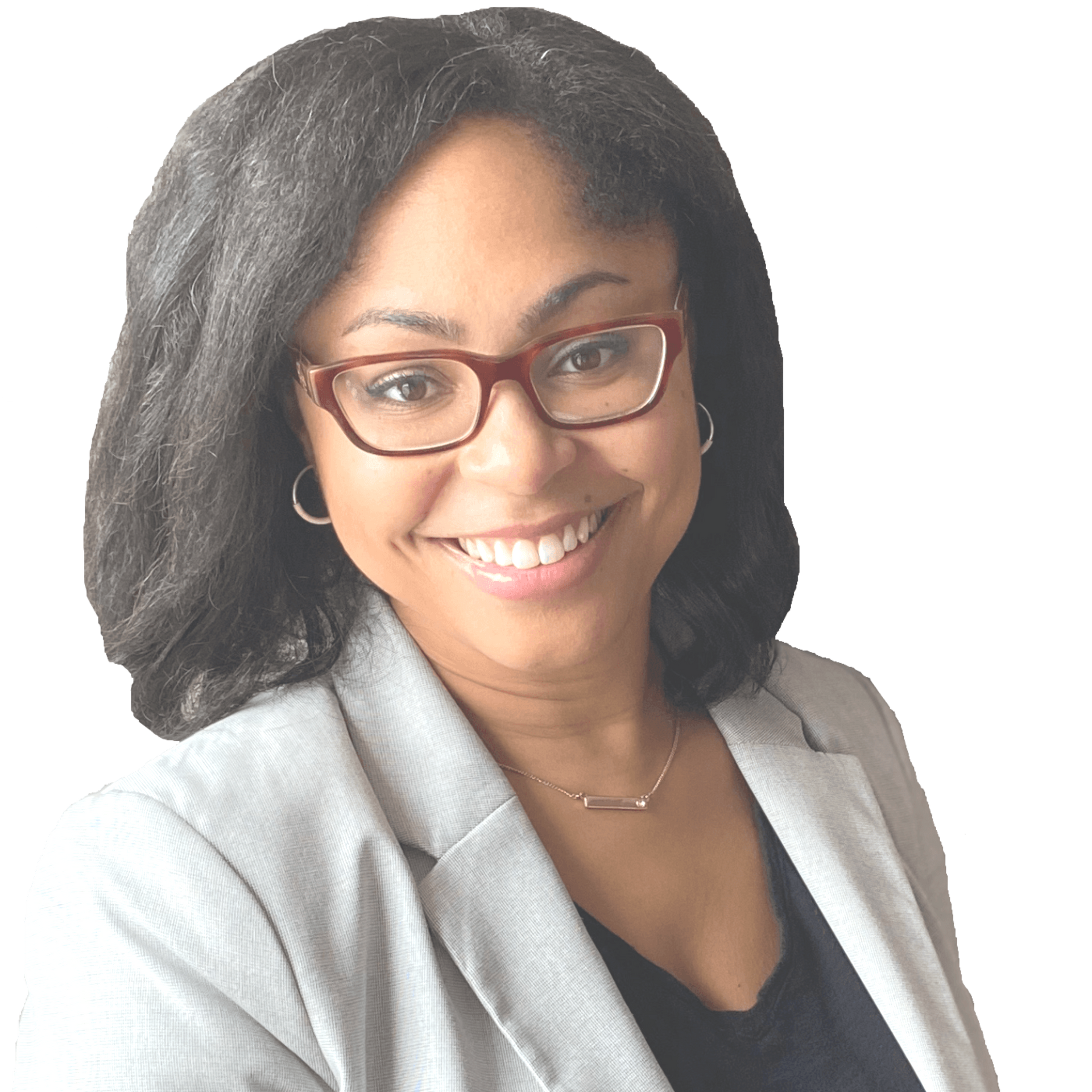 A smiling person with dark hair and glasses wears a light gray blazer over a black top against a white background.