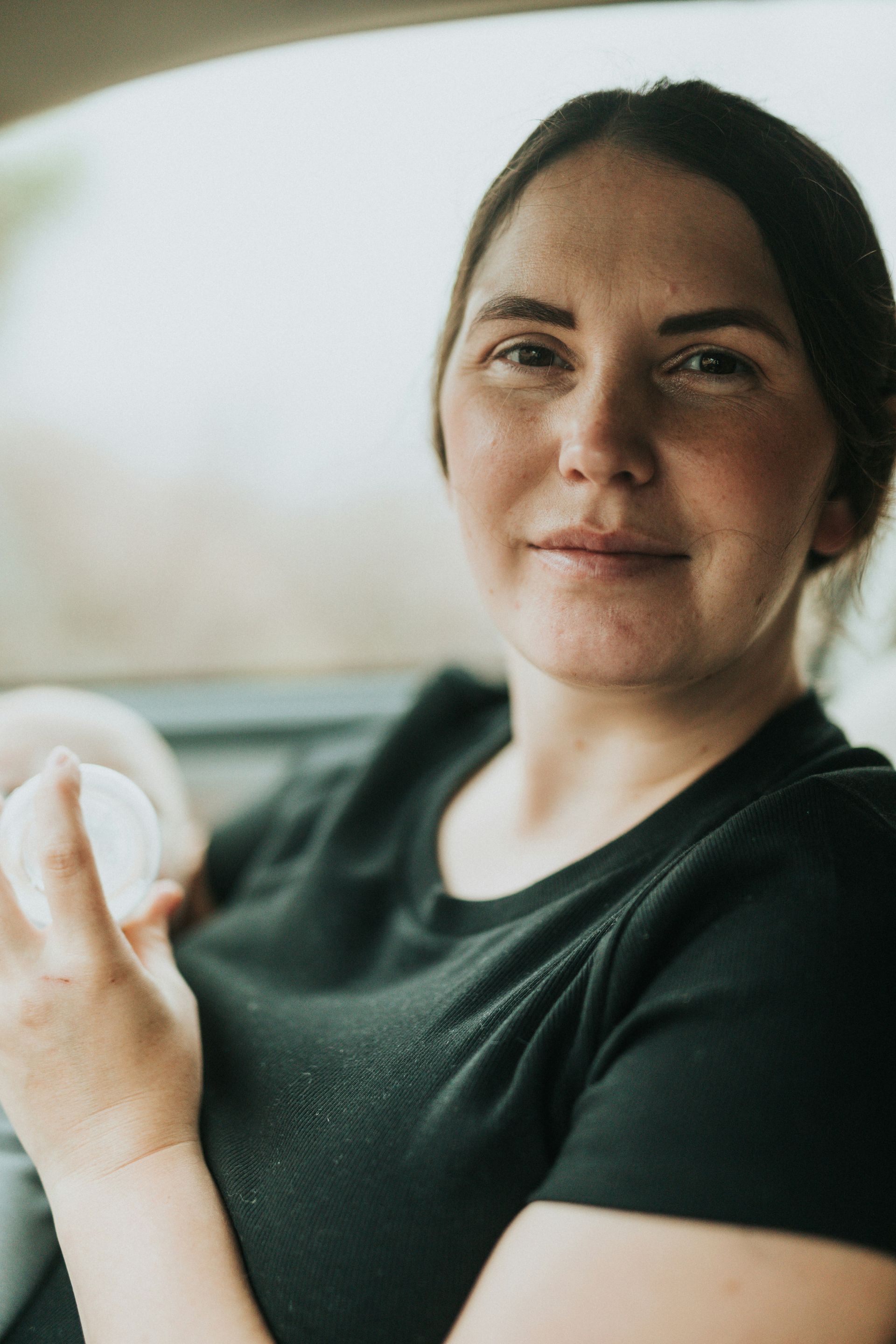 Woman feeding baby worried about postpartum anxiety