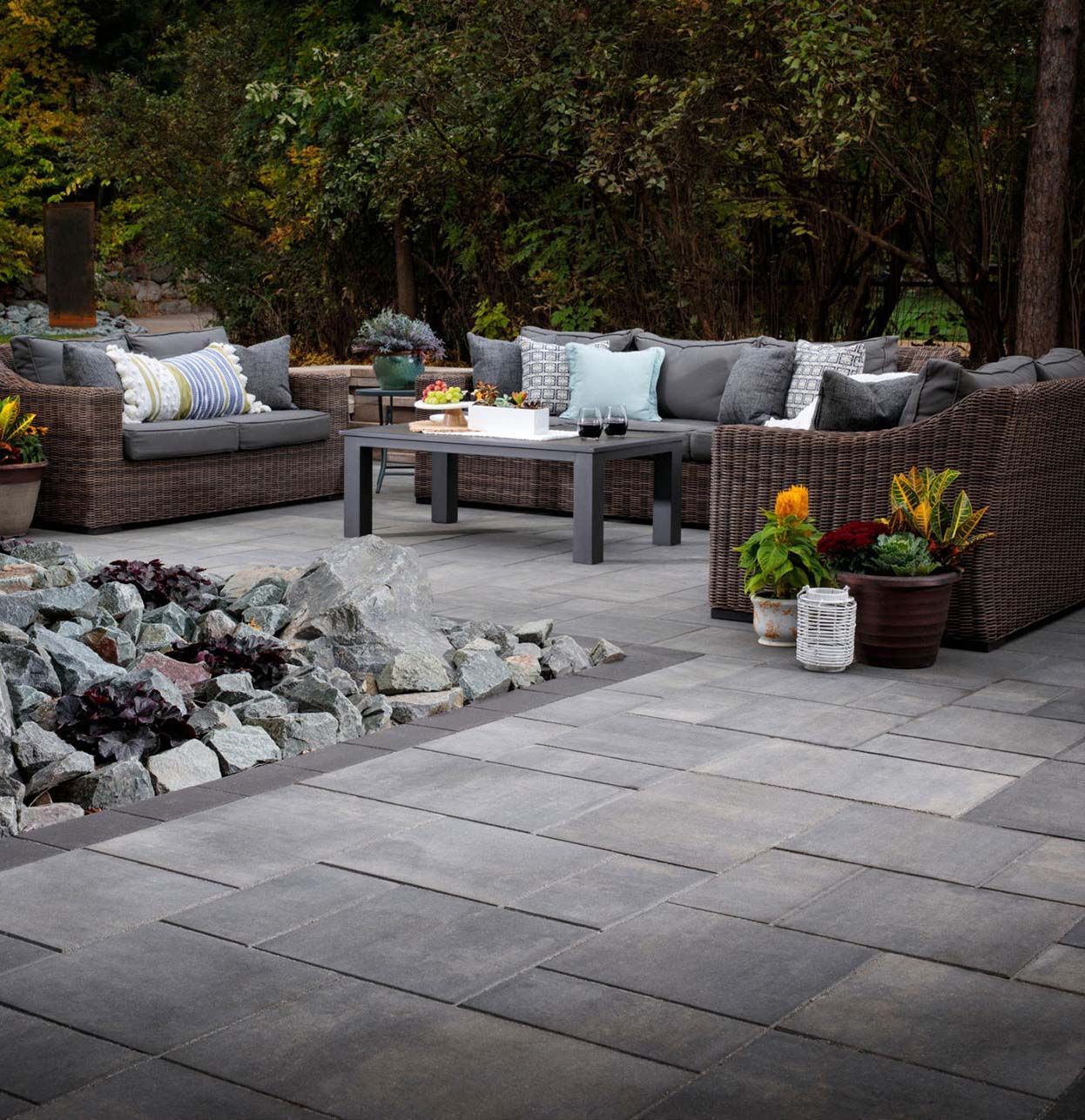 A patio with a couch and chairs and a coffee table