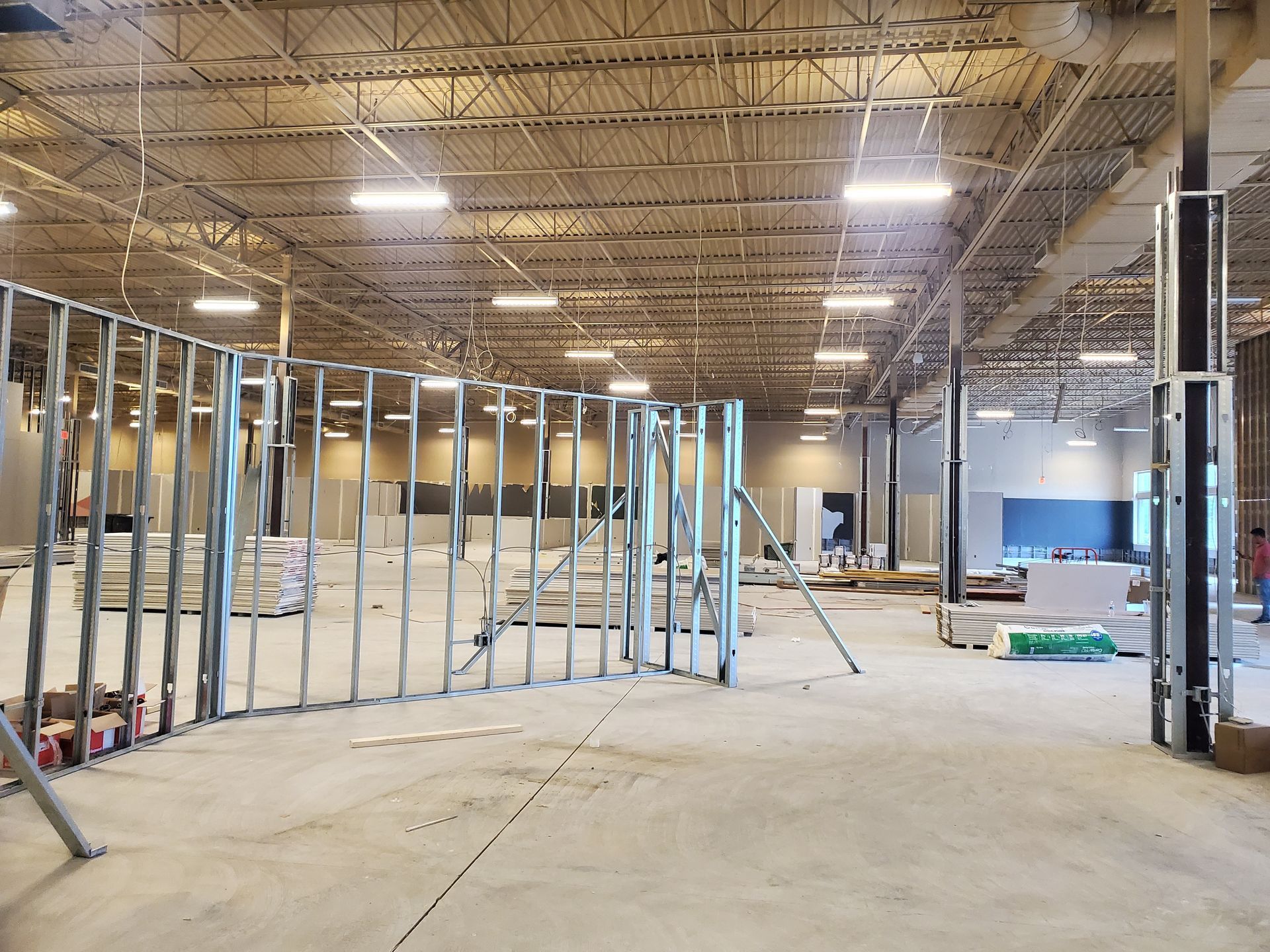 A large warehouse is being built with a lot of metal framing.