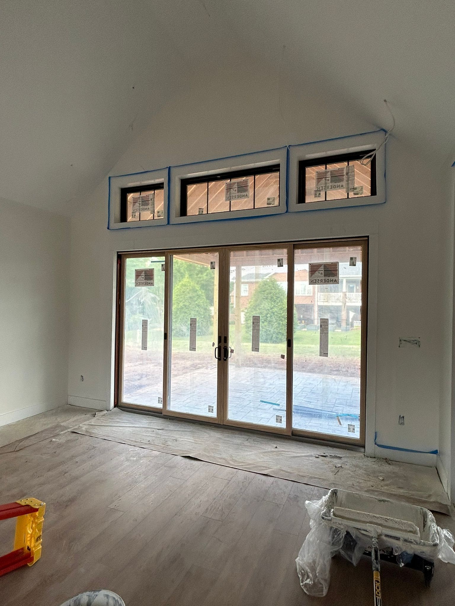 An empty room with a lot of windows and sliding glass doors