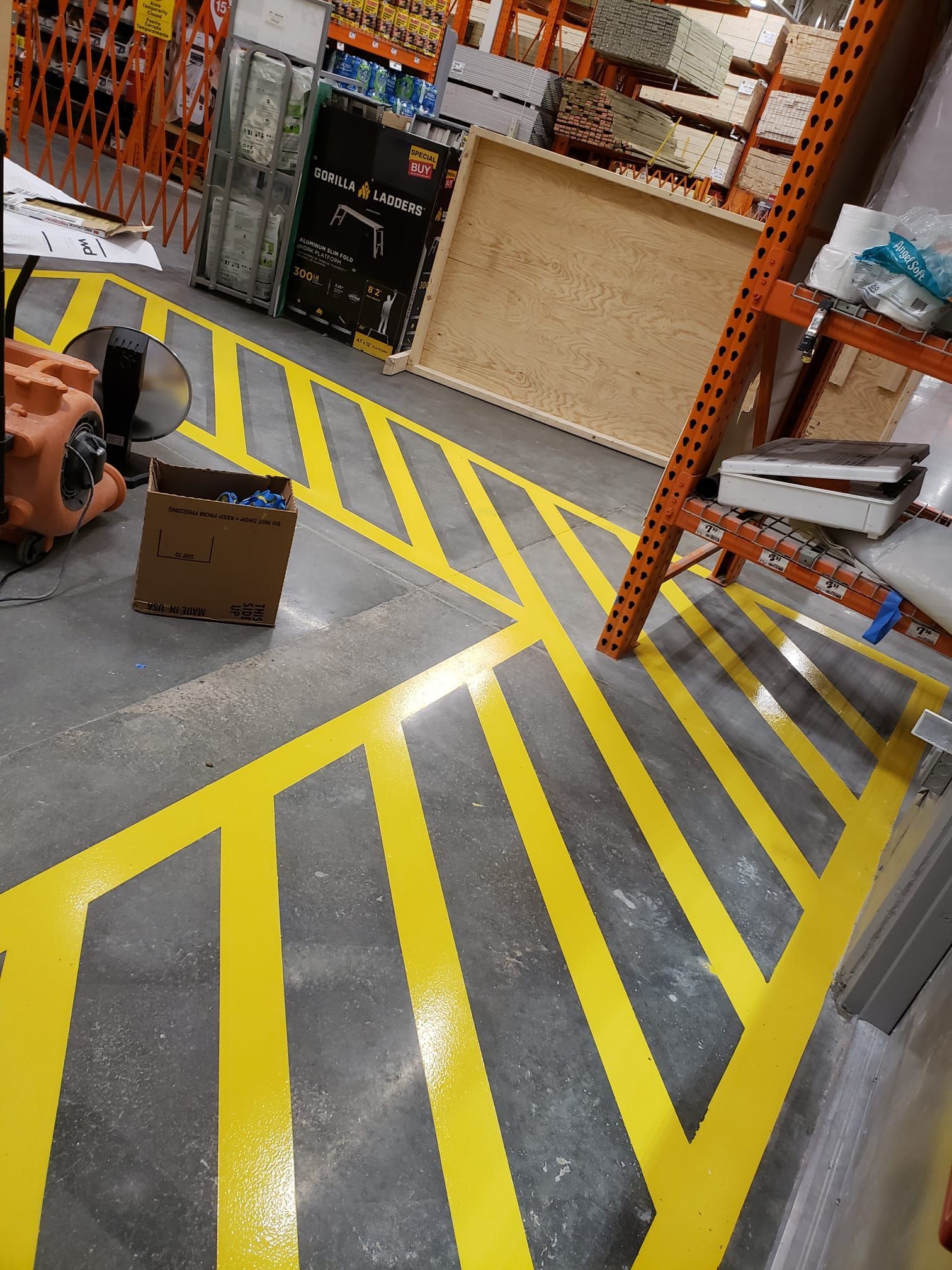 A warehouse with yellow and black stripes on the floor.