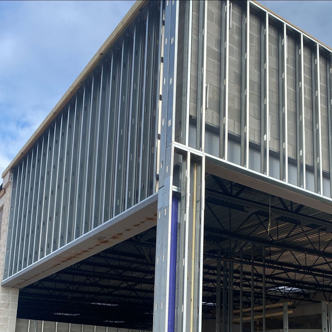 A building that is being built with a lot of metal frames
