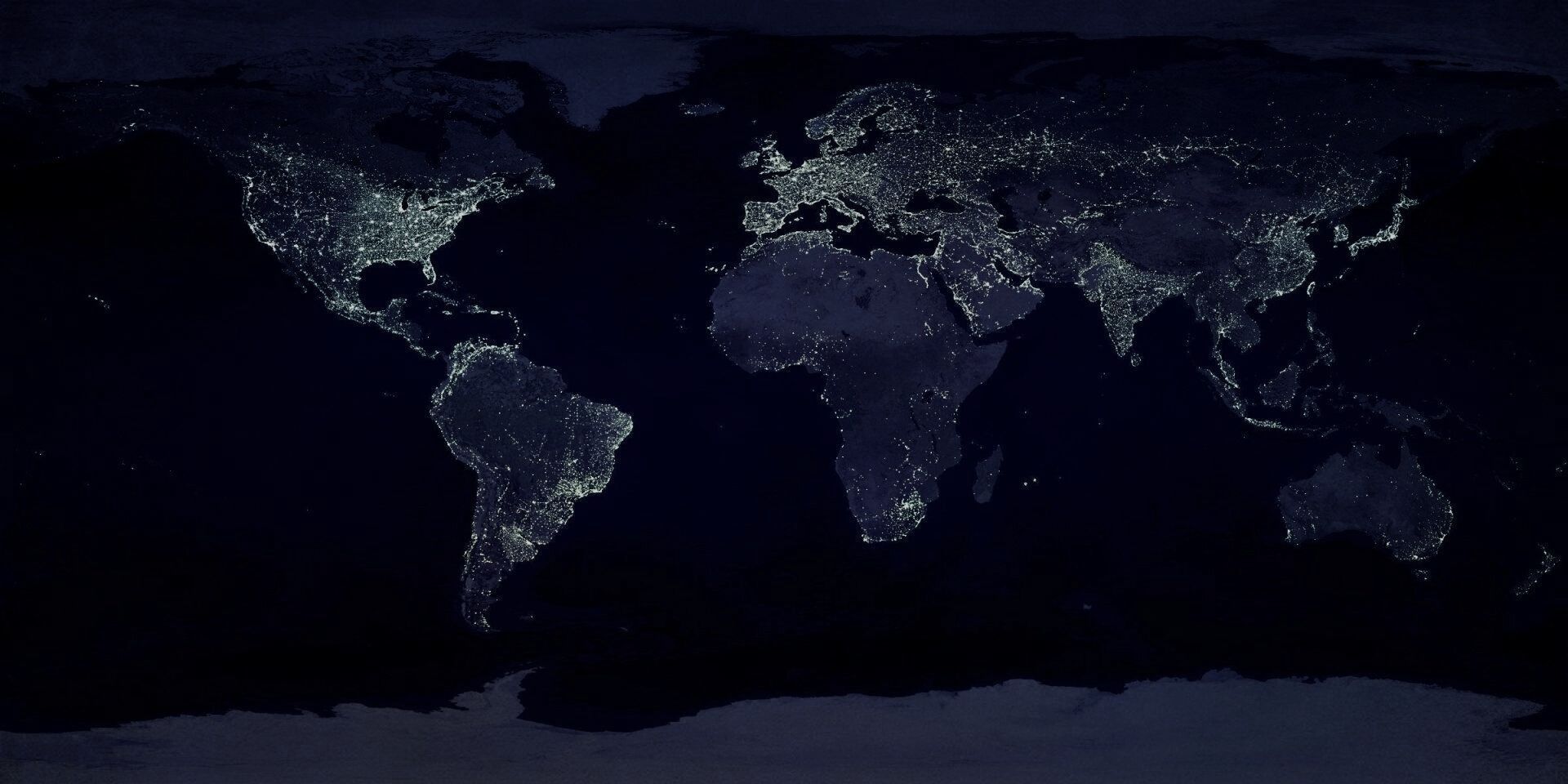 Night world map with glowing city lights on a dark background