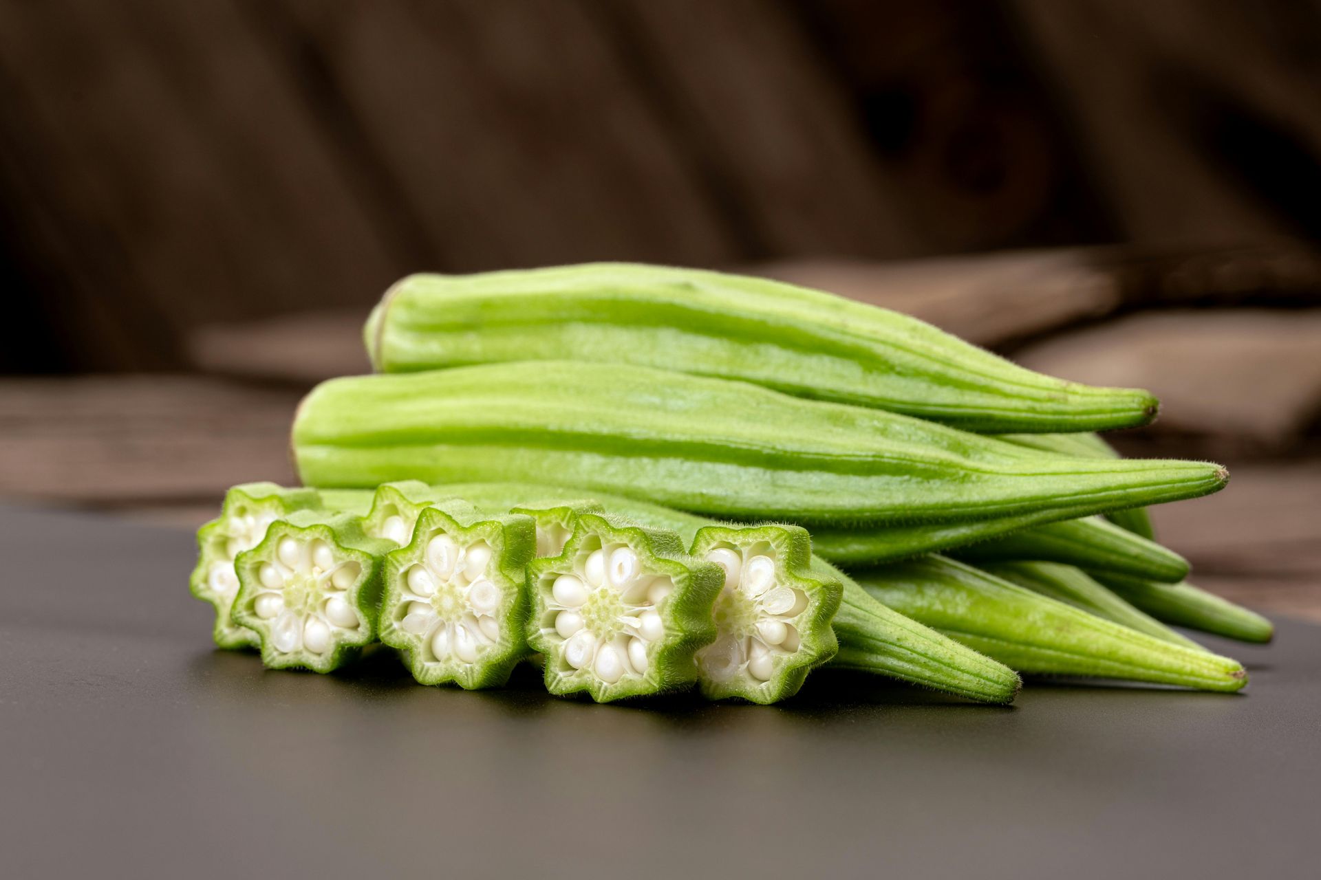 A bunch of green okra sitting on top of a table.