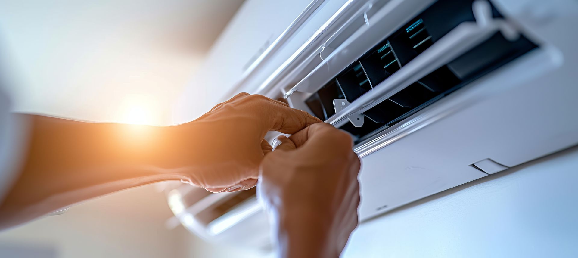 Expert AC installation contractor performing seasonal AC maintenance on a wall split unit.