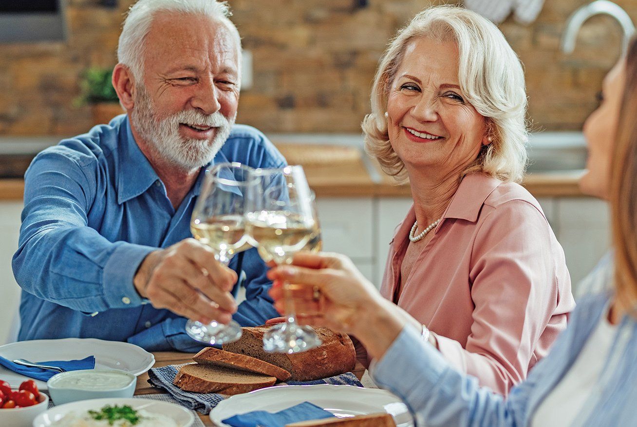 An elderly couple having wine
