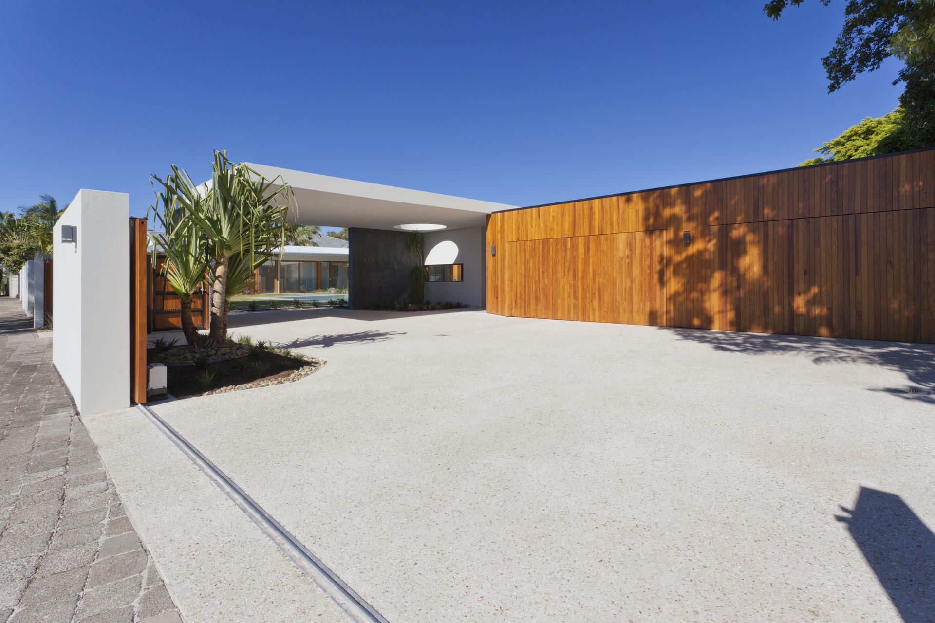 A House With a Driveway and a Large Wooden fence — Wayne Hall Concreting in South Lismore, NSW