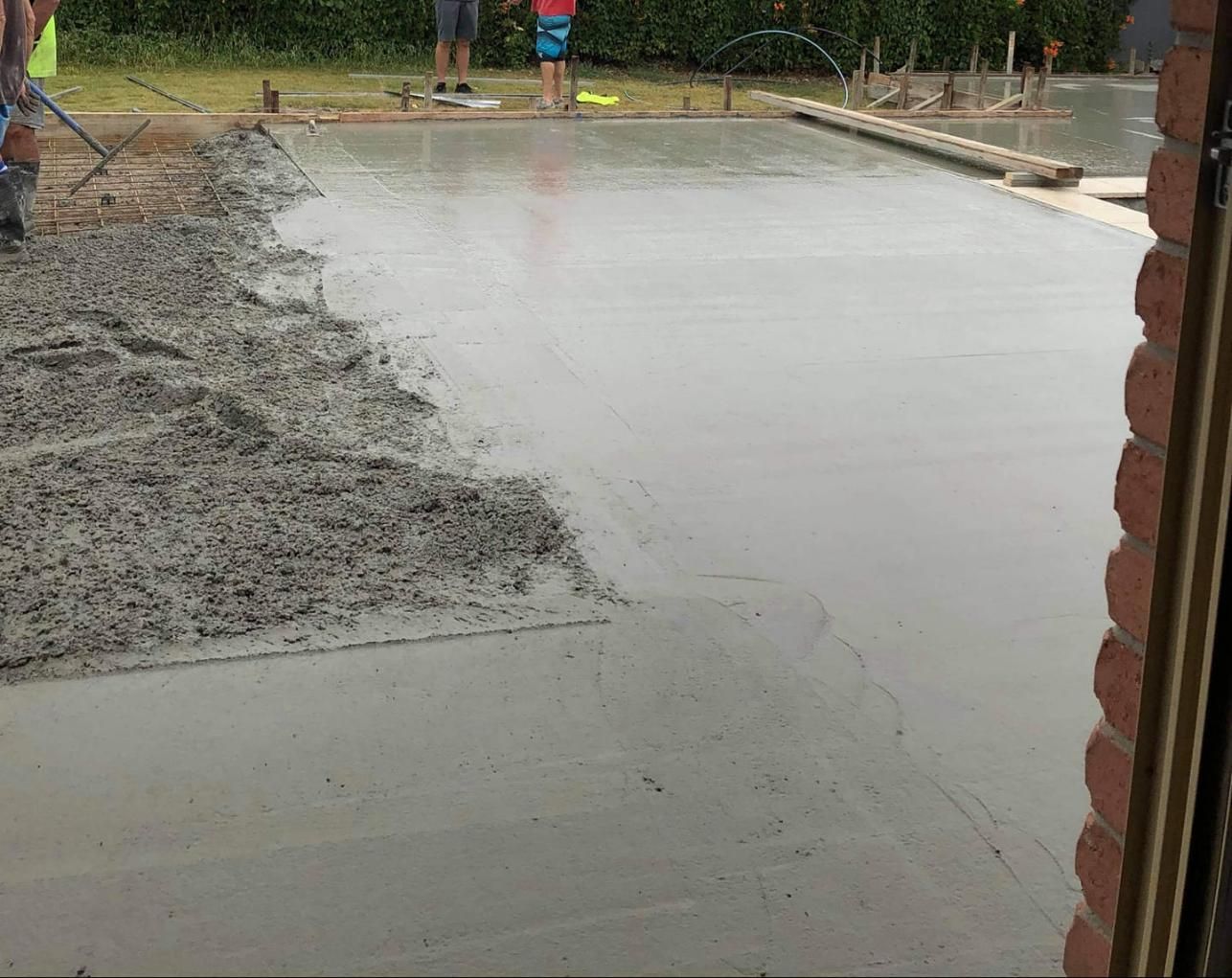 A Concrete Floor is Being Poured in a Backyard — Wayne Hall Concreting in South Lismore, NSW
