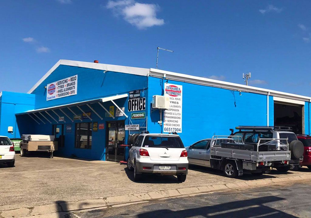 A Blue Building With Cars Parked In Front Of It — Coffs Harbour Automotive In Coffs Harbour, NSW