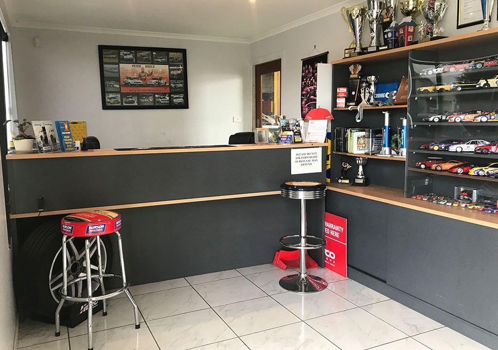 A Room With A Counter And Stools And Trophies On The Shelves — Coffs Harbour Automotive In Coffs Harbour, NSW