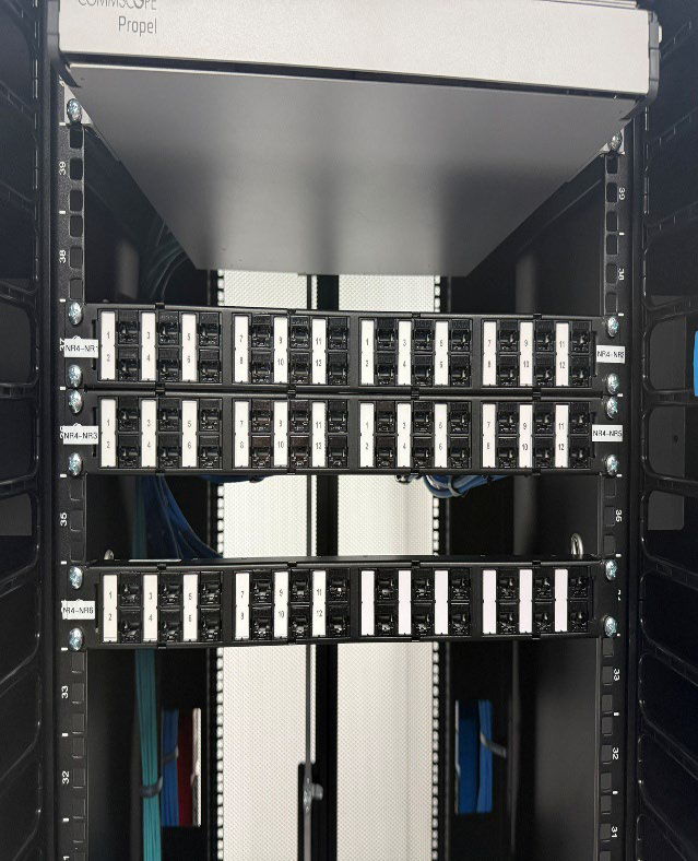 Rack-mounted server hardware with rows of drive bays in a data center cabinet