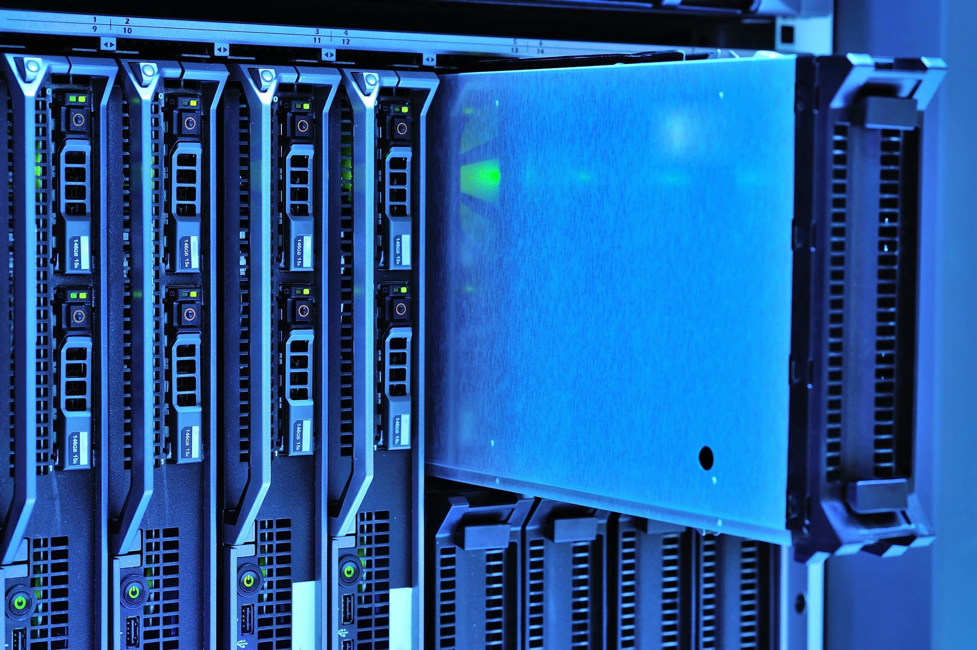 Blue-lit close-up of server racks and hardware in a data center