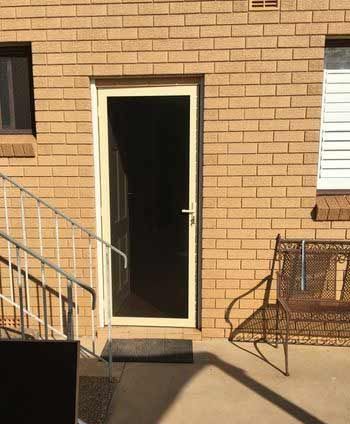 A Brick Building with a Sliding Glass Door and Stairs - Penrith, NSW - ClearShield-Penrith