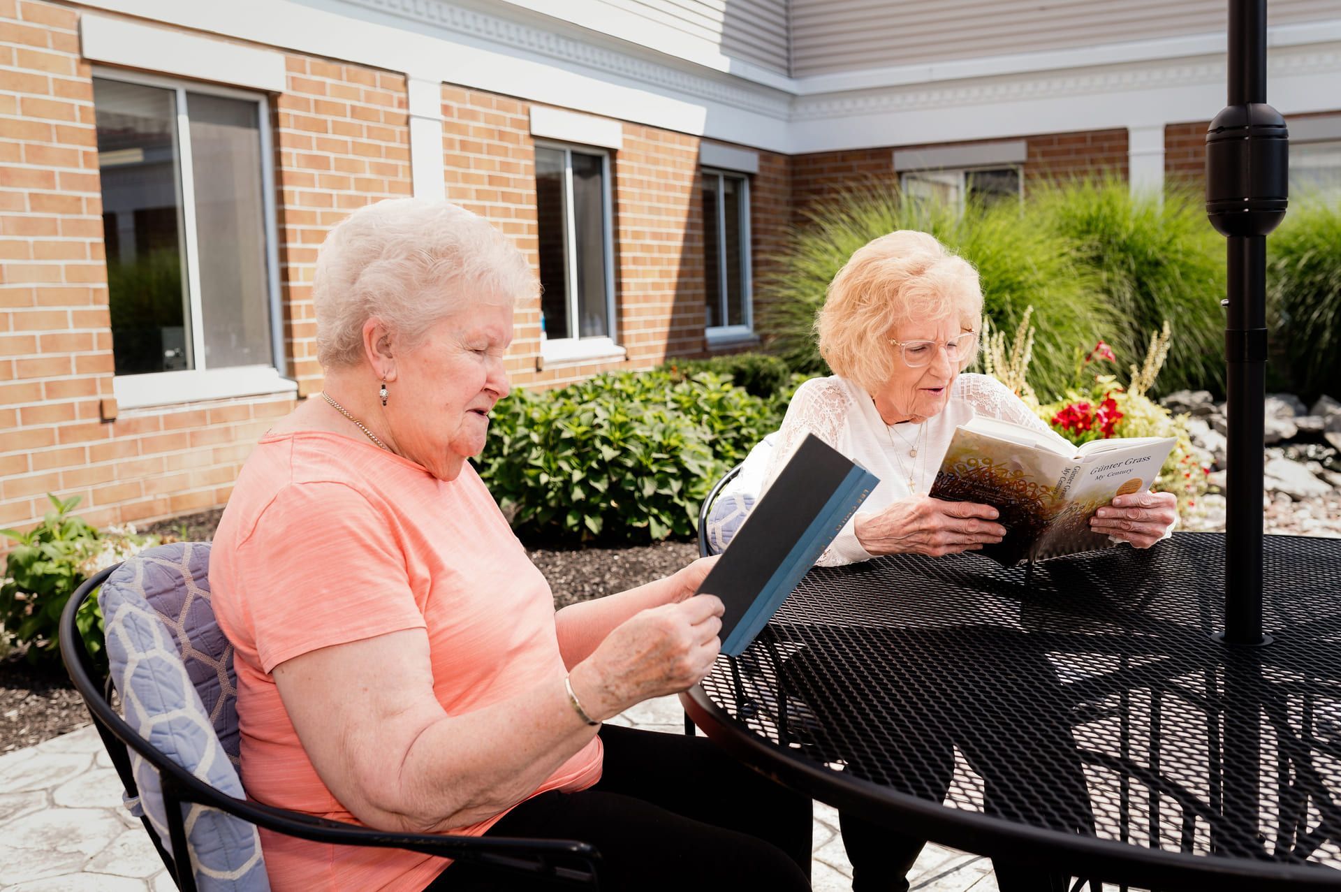 two elderly women enjoying patio at assisted living community