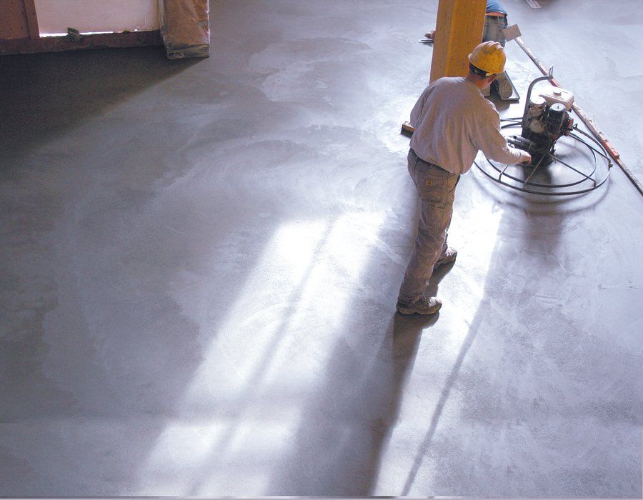 worker using the rotating trowel