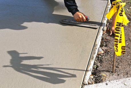 worker flattens the cement