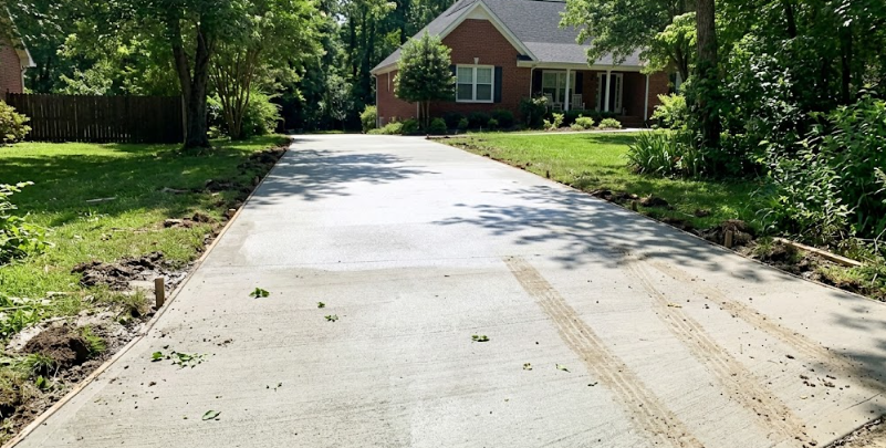 Professional concrete contractors in Laurel MD smoothing and finishing a fresh concrete pour.