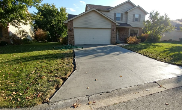 Freshly poured and perfectly smooth concrete driveway for a residential home.