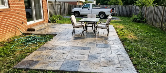 Beautiful stamped concrete backyard patio designed to look like flagstone in Columbia MD.
