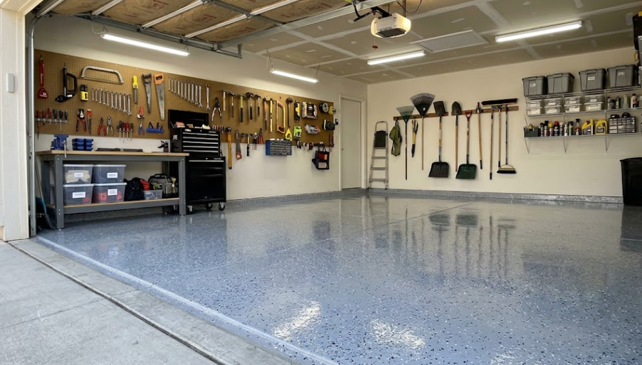 A clean, durable gray epoxy concrete floor coating inside a bright residential garage.