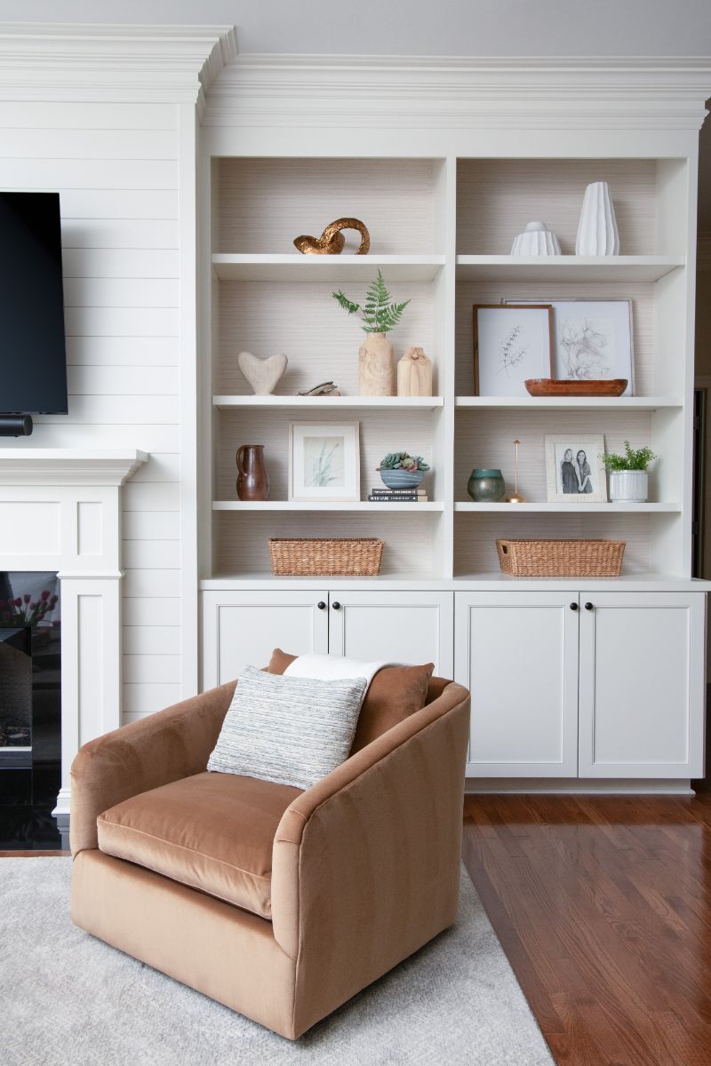 A living room with a chair , shelves , and a fireplace - Charlotte, NC