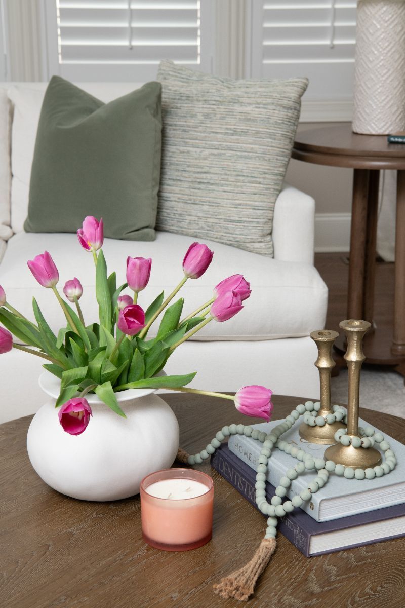 A vase of pink tulips sits on a coffee table in a living room - Charlotte, NC