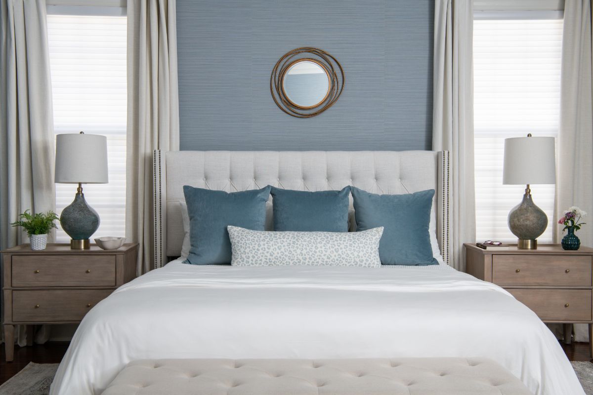 A bedroom with a bed , nightstands , lamps and a mirror on the wall - Charlotte, NC
