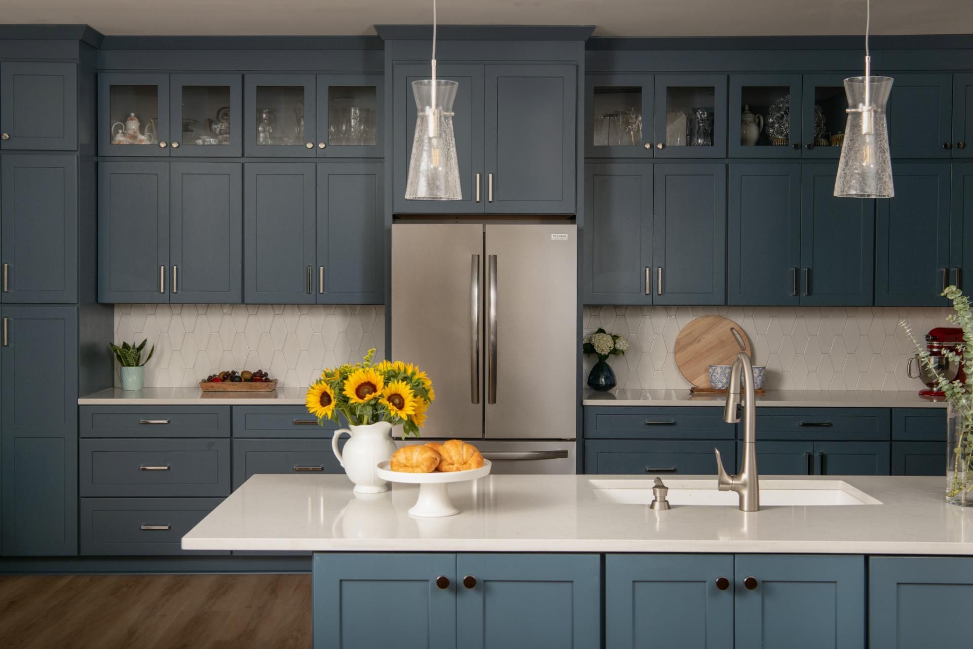 Blue kitchen with stainless steel appliances, white countertops, and sunflowers | Matthews, NC | An Inspiring Home