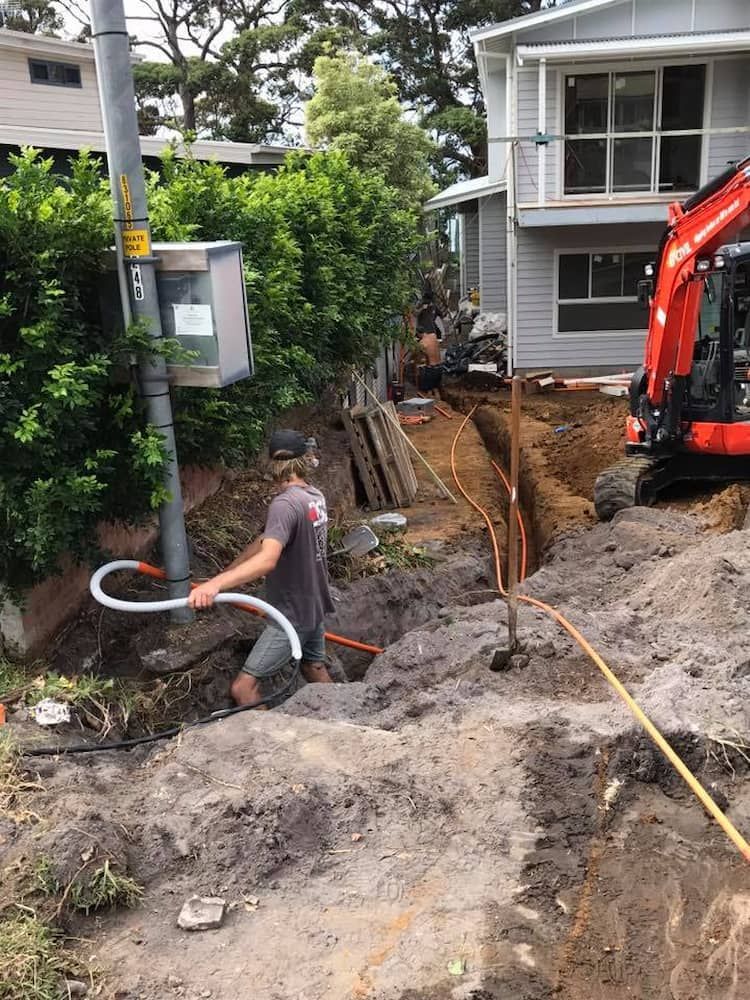 A Man is Digging a Hole in the Dirt in Front of a House — BeCivil in Tomerong, NSW