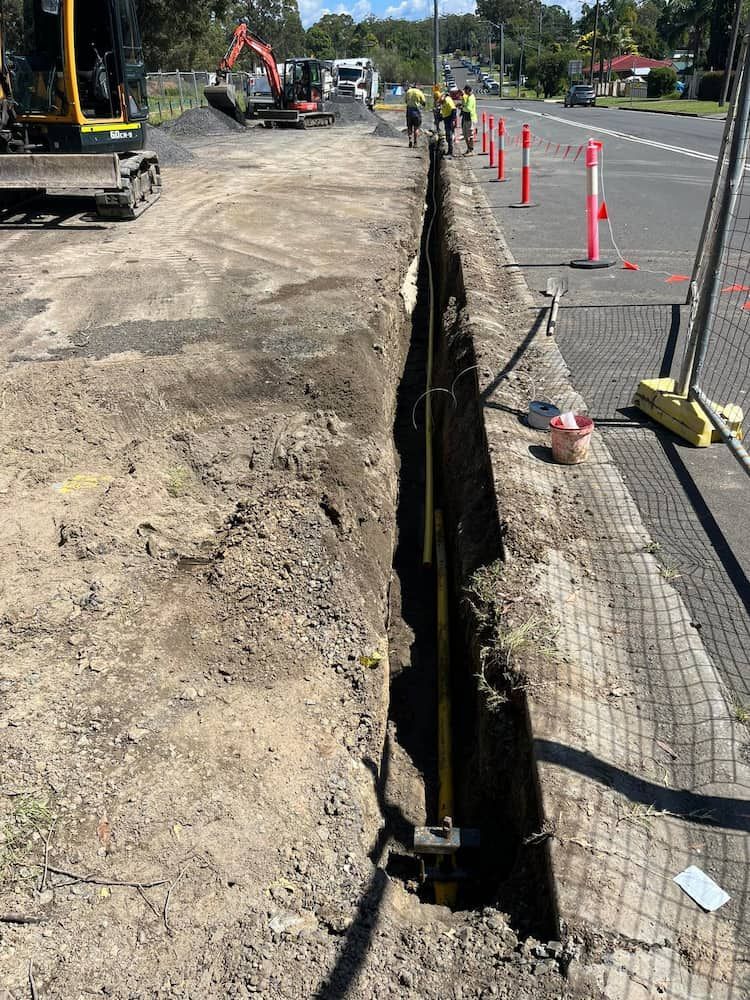 A construction site with a hole in the ground and a bulldozer — BeCivil in Tomerong, NSW