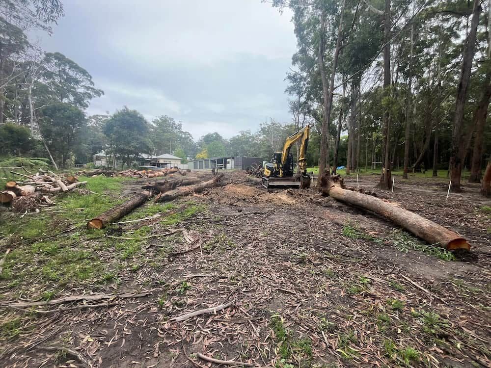 A Digger surrounded by Trees on a empty space of Land — BeCivil in Ulladulla, NSW