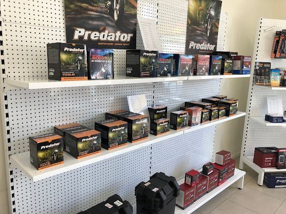 A Shelf Filled With Boxes Of Predator Batteries In A Store — Coast 2 Coast Batteries in Erina, NSW