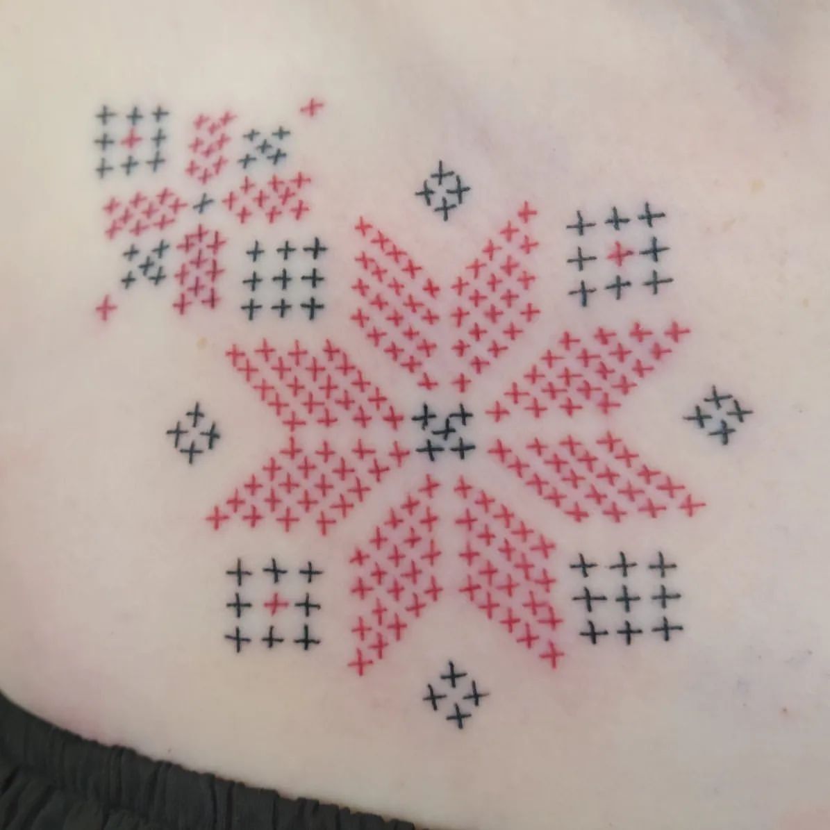 Cross Stitch Tattoo by Sheila Anderson at Crimson Empire Tattoo in Edmonton Alberta Canada