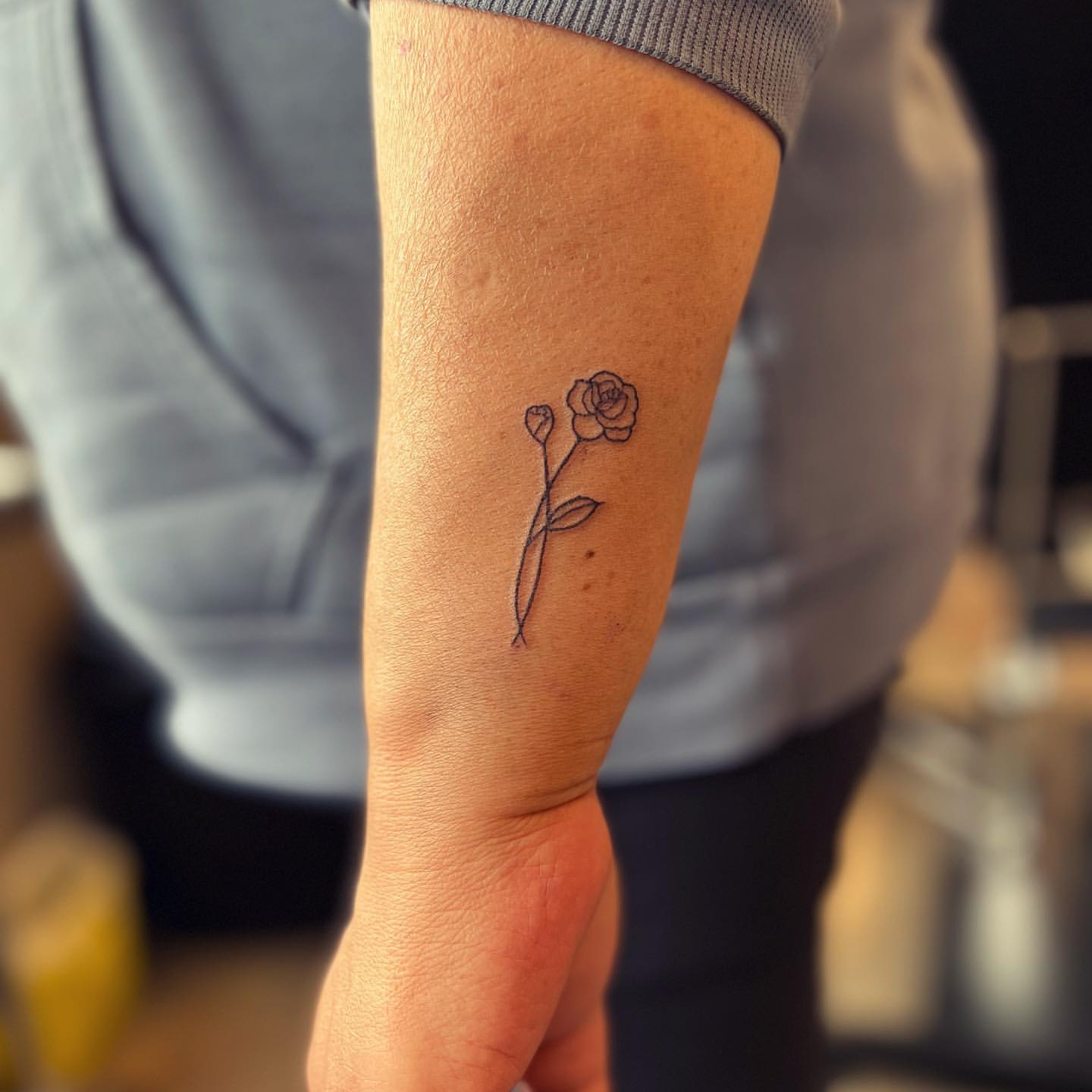 Fine Line Rose Tattoo by Vinny Nguyen at Crimson Empire Tattoo in Edmonton Alberta Canada