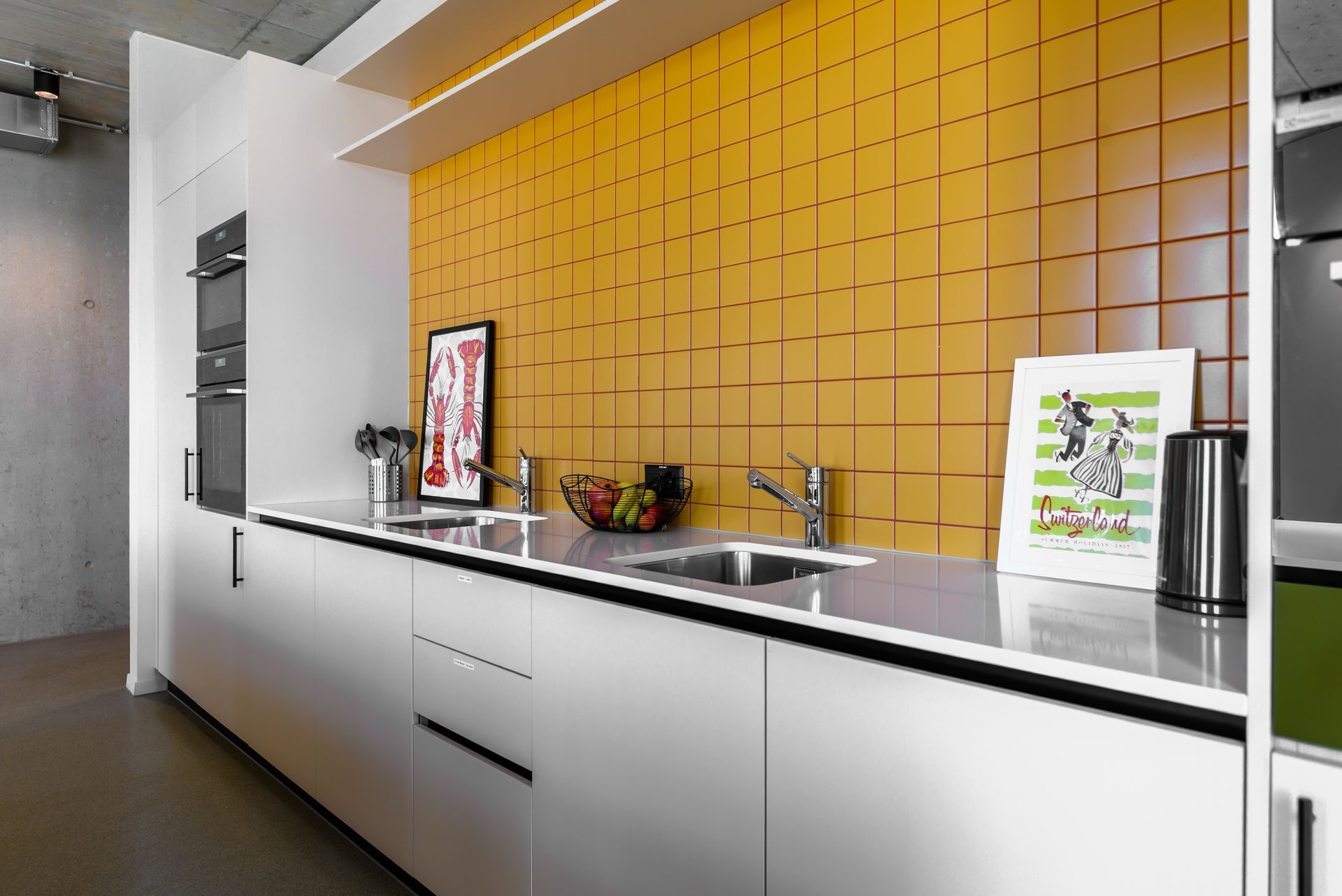 Modern kitchen with white cabinets, black countertop, and yellow tile backsplash
