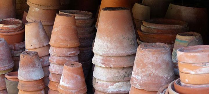 A bunch of clay pots are stacked on top of each other.