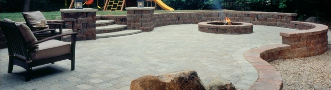 There is a fire pit in the middle of the patio.