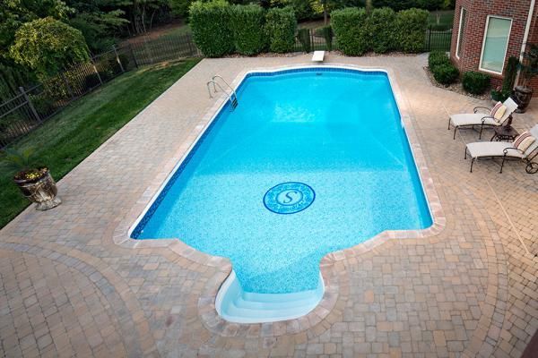 An aerial view of a large swimming pool in a backyard.