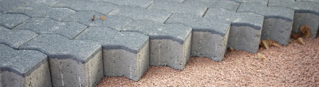 A close up of a row of bricks on a sidewalk.